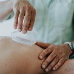 A man performs treatment on a back