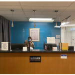 A receptionist waits to greet clients. 