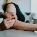 A physio is seen providing IMS to client in a physio clinic