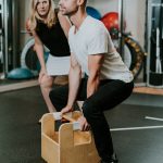 A physio looks at a client performing a task van sports physio 