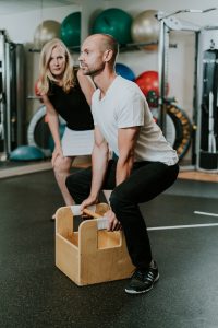 A physio looks at a client performing a task